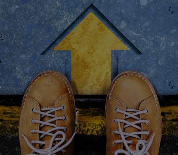 Shoes on a start line with forward facing arrow