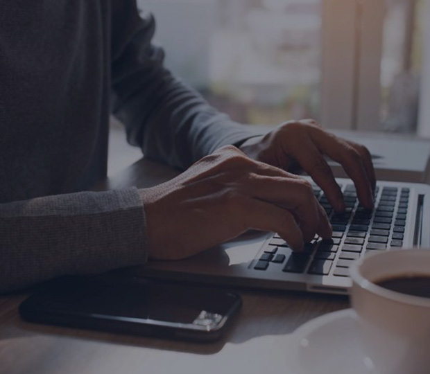 man typing on keyboard