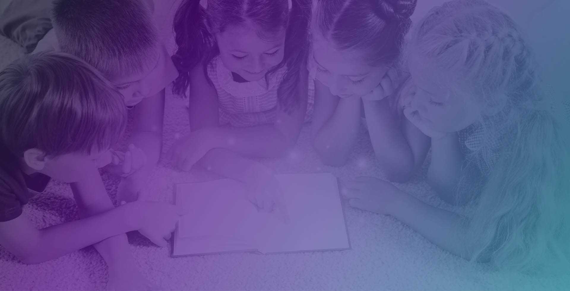 Children reading a book together