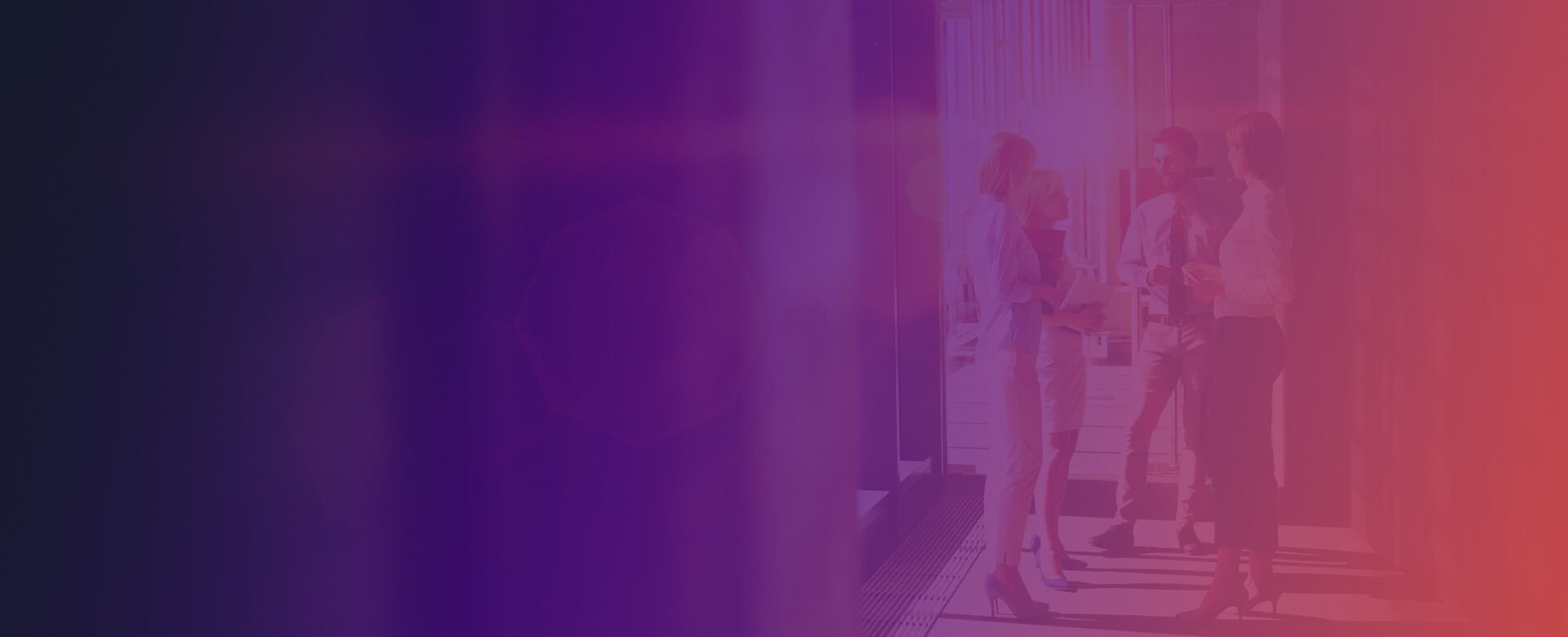 Male and female co-workers standing in a corridor discussing ideas on the way to a meeting