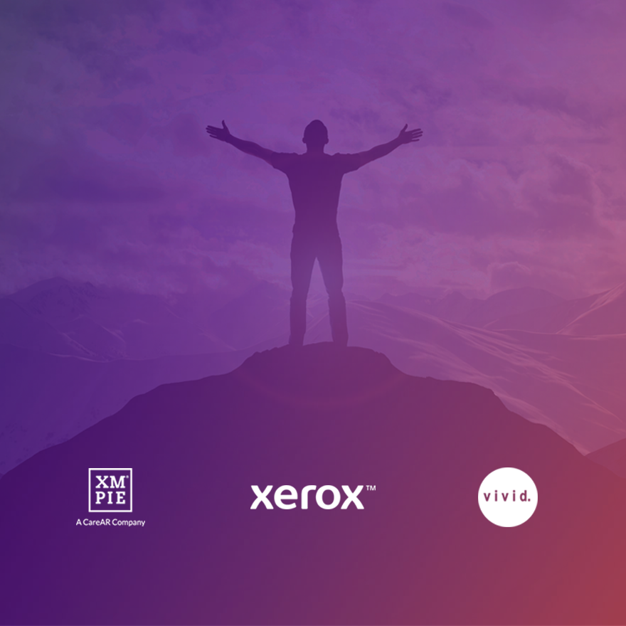 Man on top of a mountain with the XMPie, Xerox and Vivid logo's underneath