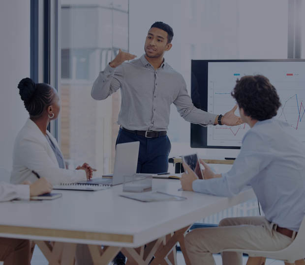 Man presenting to 2 people